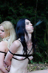 TS and a chick getting their throats fucked while tied up in the wild