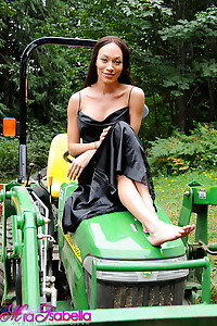 Transsexual sweetie Mia Isabella posing on a tractor